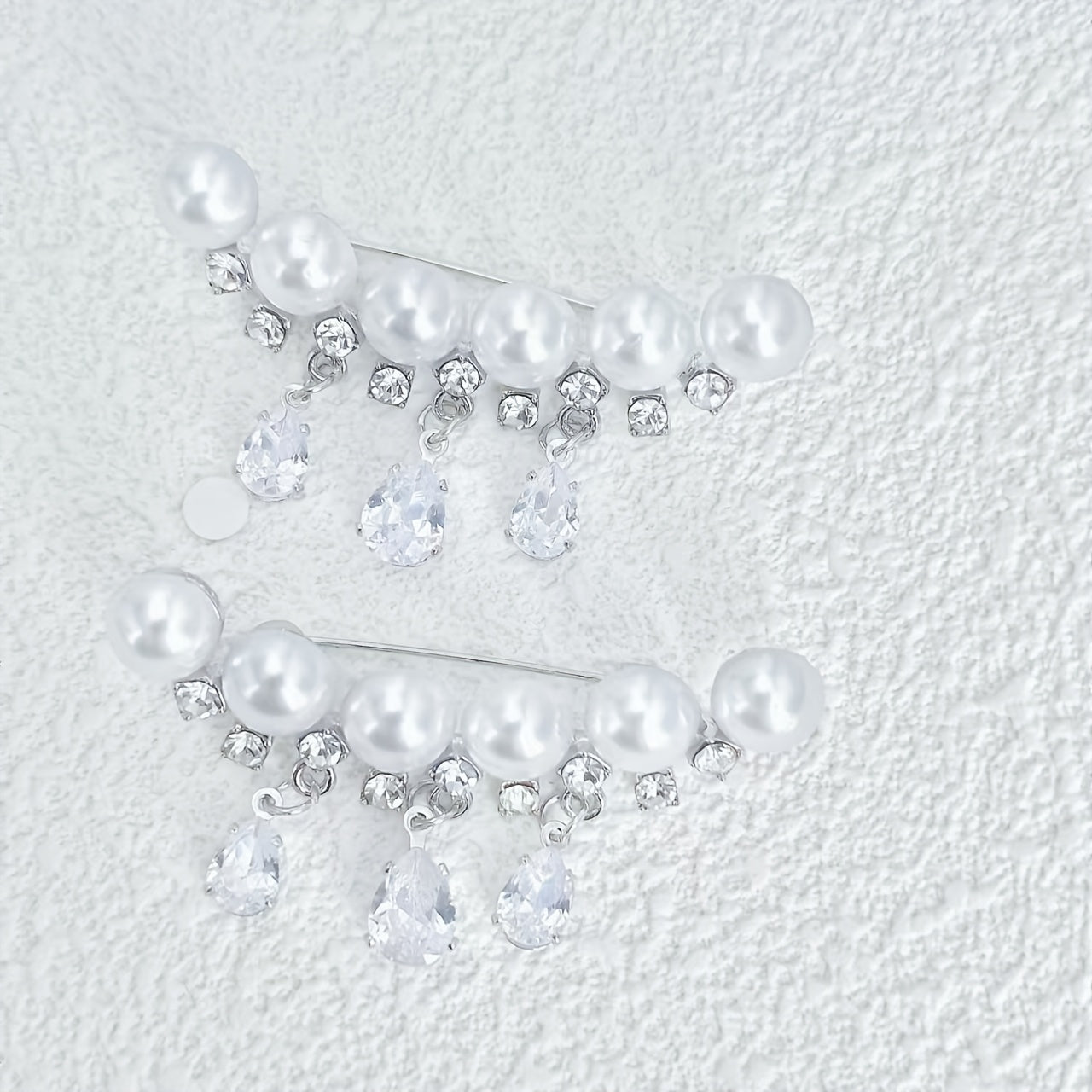 High-quality pearl, rhinestone, and zirconia brooches available in 1 or 2 pieces. These elegant accessories are perfect for daily wear and feature tassel water drop designs to add a touch of sophistication. Protect yourself from exposure with these