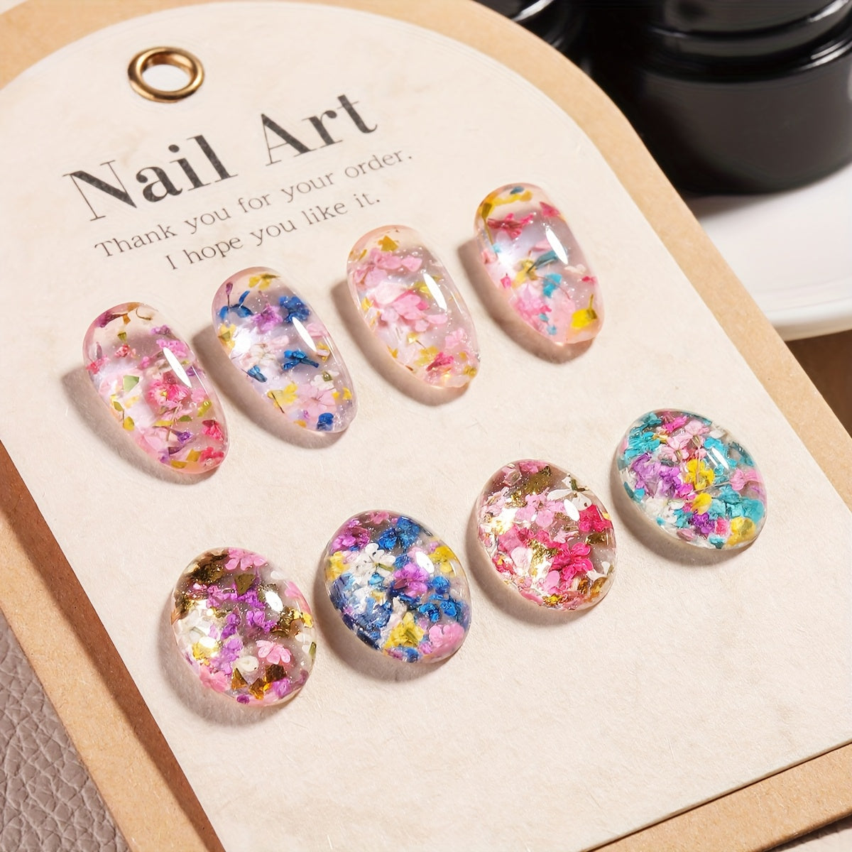 1 bottle of unscented metal compatible soak-off gel nail polish with dried flower design in colors of pink, red, yellow, and blue. Ideal for DIY manicures and nail art.