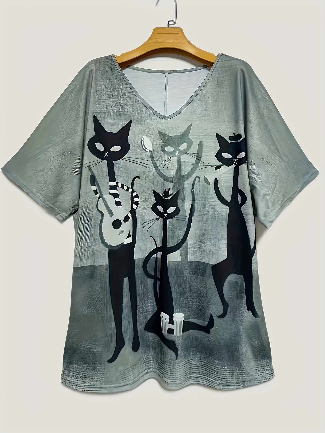 Women's oversized V-neck t-shirt with elegant cartoon cat print, made of 95% polyester and 5% elastane. It has medium stretch, short sleeves, and is made of all-season knit fabric.