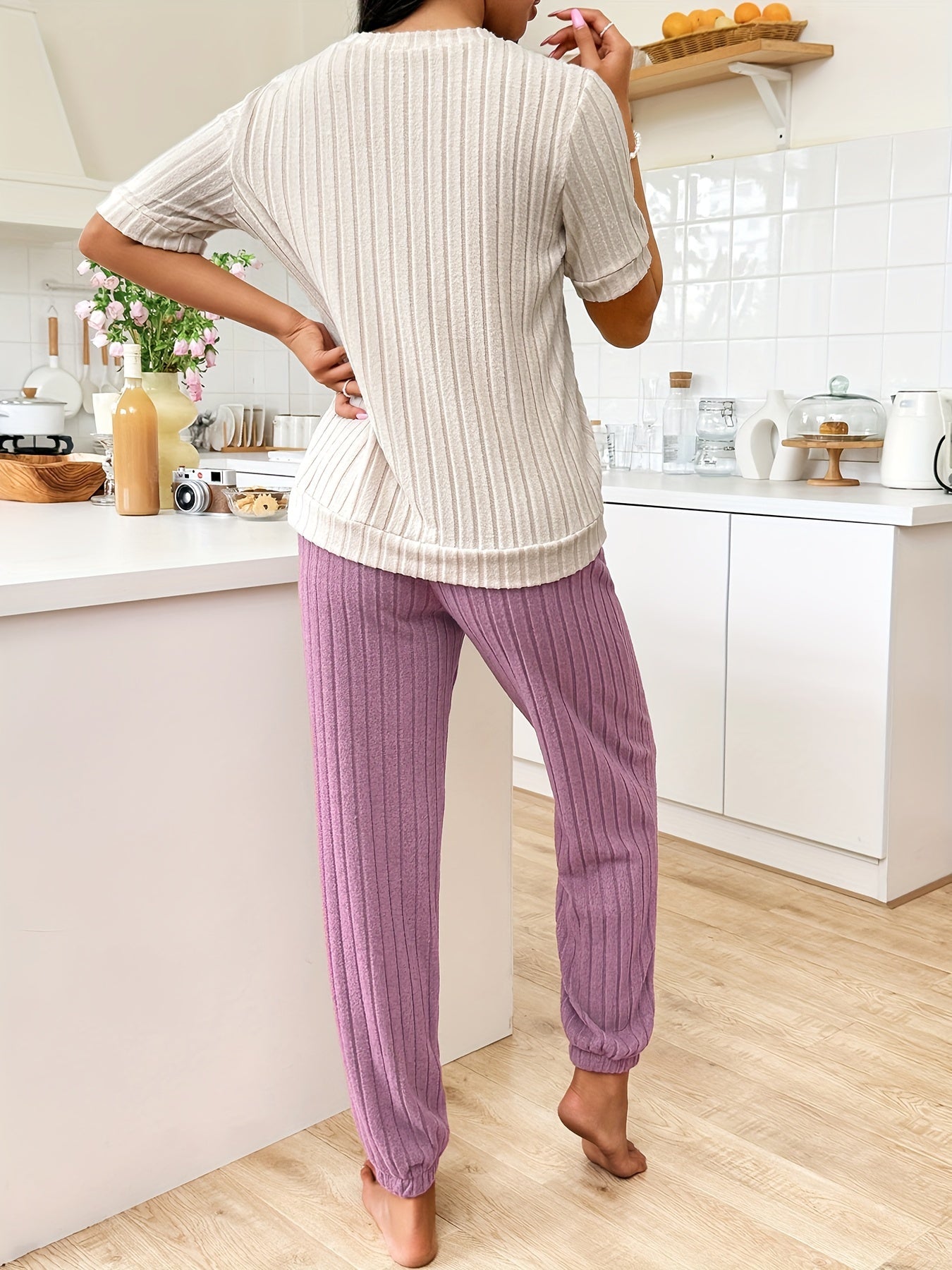 Women's heart and letter print pajama set with short sleeve top and joggers, relaxed fit for comfortable summer nightwear.