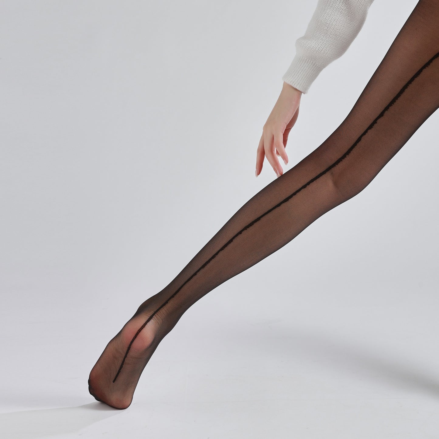 Ultra-thin black pantyhose with back seam detail for a sleek, professional look.