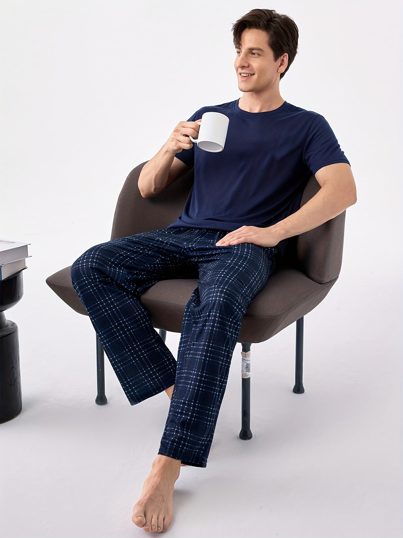 Men's blue pajama set with classic round neck, short sleeves, and plaid trousers for cozy loungewear.