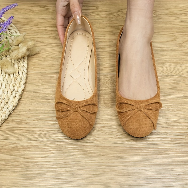 Women's bowknot flat shoes in solid color suedette, slip-on style with soft sole.