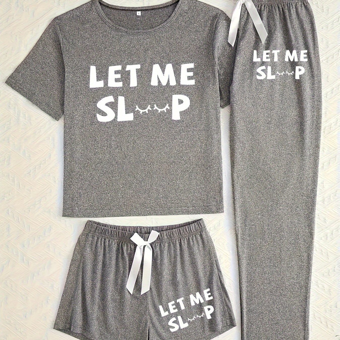 Casual pajama set with letter print, short sleeve top, long pants, and shorts.