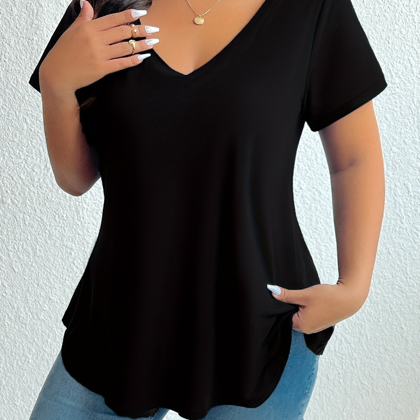 Chic black V-neck t-shirt for plus size women, made from soft polyester and elastane blend. Machine washable and flattering hemline, essential summer wear.