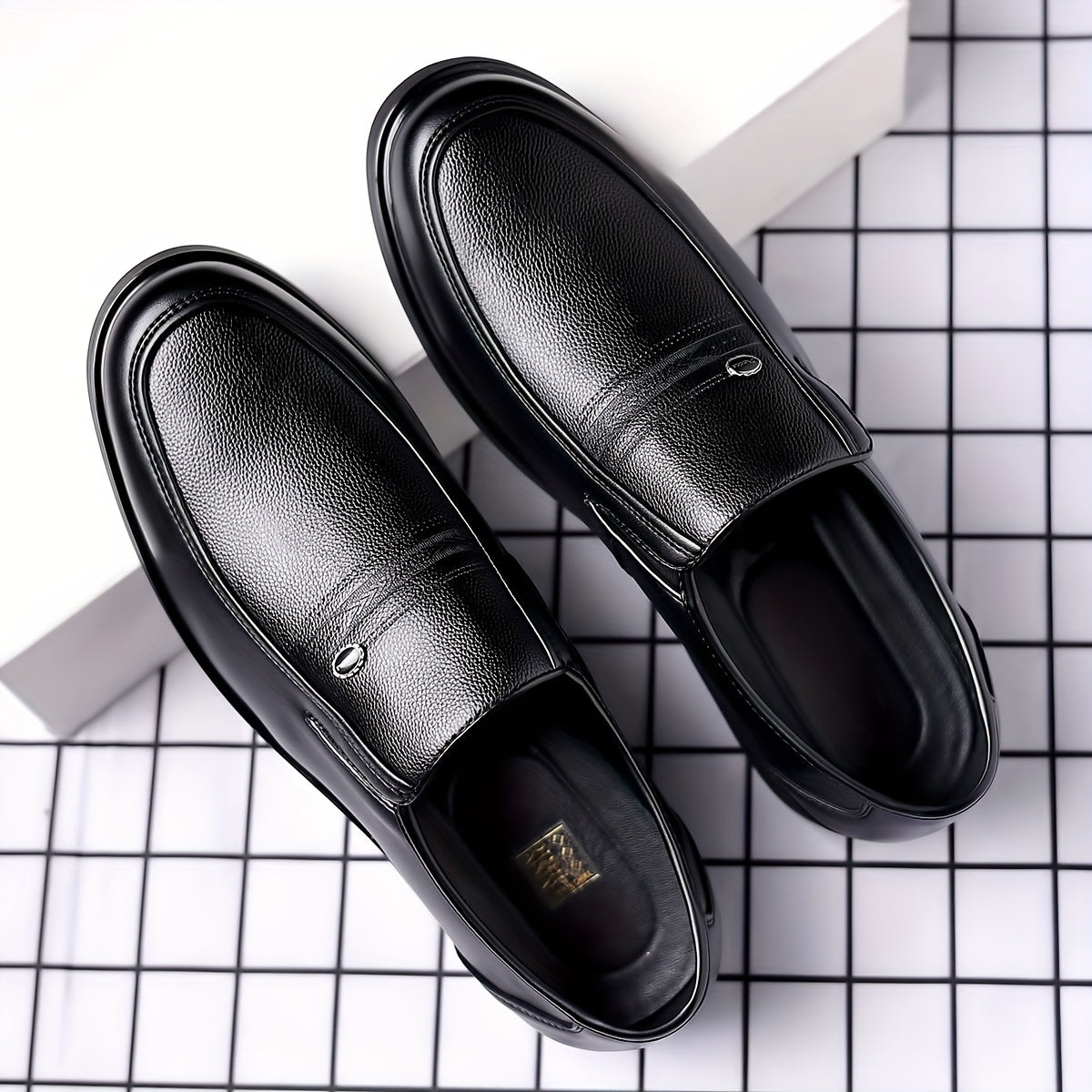 Black slip-on loafers for men featuring a rubber sole, round toe, and embossed logo - perfect for casual attire.