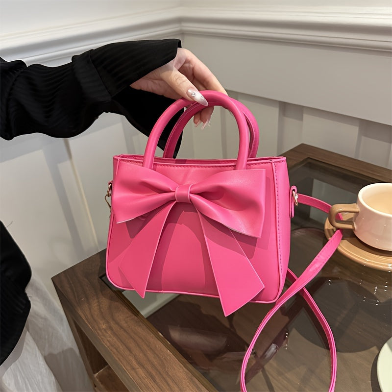 Faux leather crossbody bag with bow embellishment, adjustable strap, zipper closure, solid color, edge paint, animal theme from Baigou Production Area.