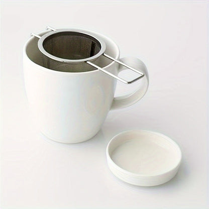 Tea infuser made of durable stainless steel for loose leaf tea, with lid and handle for convenient use at home, office, restaurant, or hotel. Features micropore metal strainer basket.