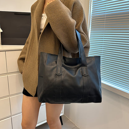 Chic black tote bag for women with foldable design, zip closure, multiple compartments, and polyester lining.