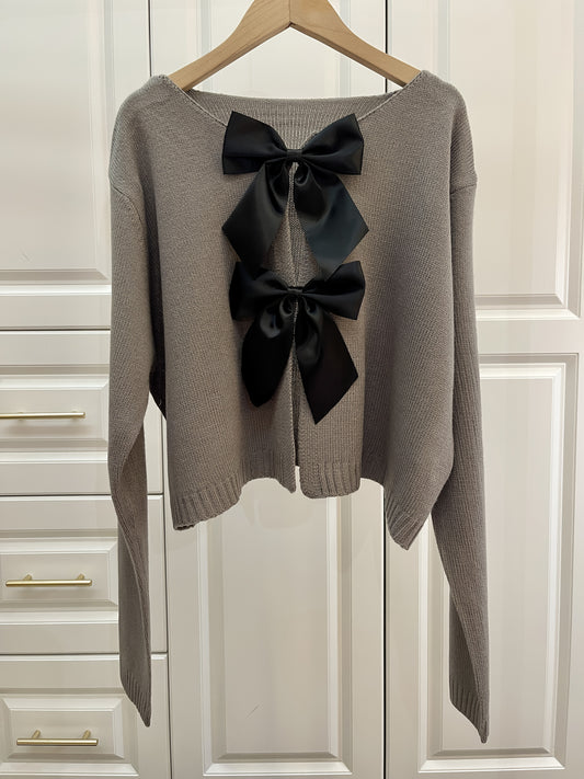 Stylish women's lightweight acrylic knit cardigan with large bow tie, perfect for spring and fall. White with black bow detail.