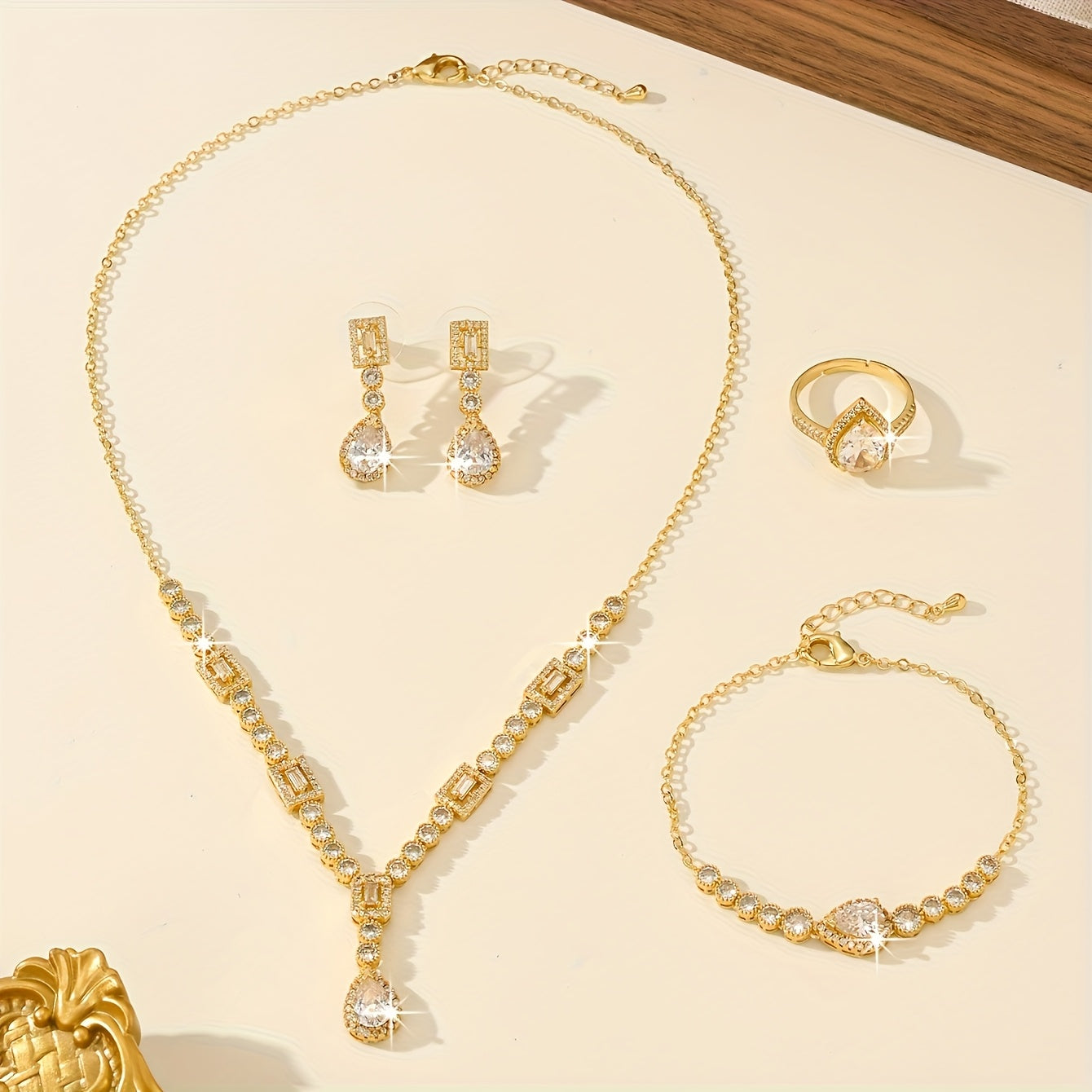 Luxury Jewelry Set Featuring 5 Pieces, Crafted from 18K Golden Plated Copper with Synthetic Cubic Zirconia Stones in a Geometric Teardrop Design. Includes Necklace, Earrings, Ring, and Bracelet, Perfect for Both Daily Wear and Wedding Occasions.