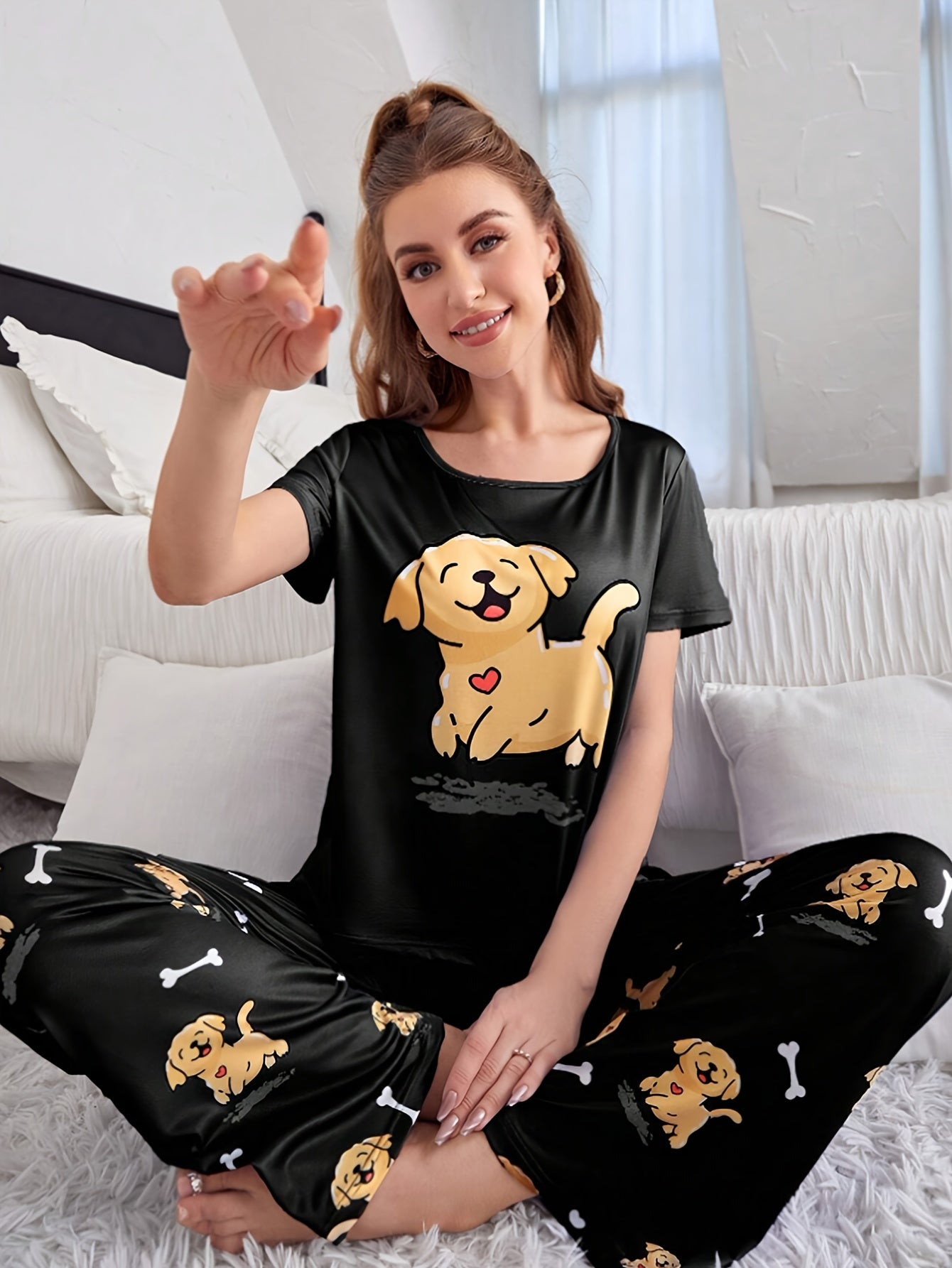 Women's sleepwear set with cute puppy print, short sleeve top, and elastic pants.