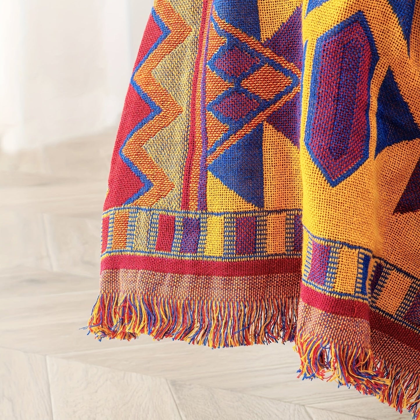 Add a touch of Aztec charm to your home with this Bohemian-inspired reversible throw blanket. Featuring a geometric pattern, chunky knit weave, tassel embellishment, and made from all-season multipurpose synthetic fiber, it is the perfect couch protector