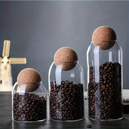 Airtight glass kitchen jars with cork lids for coffee, tea, and spices.