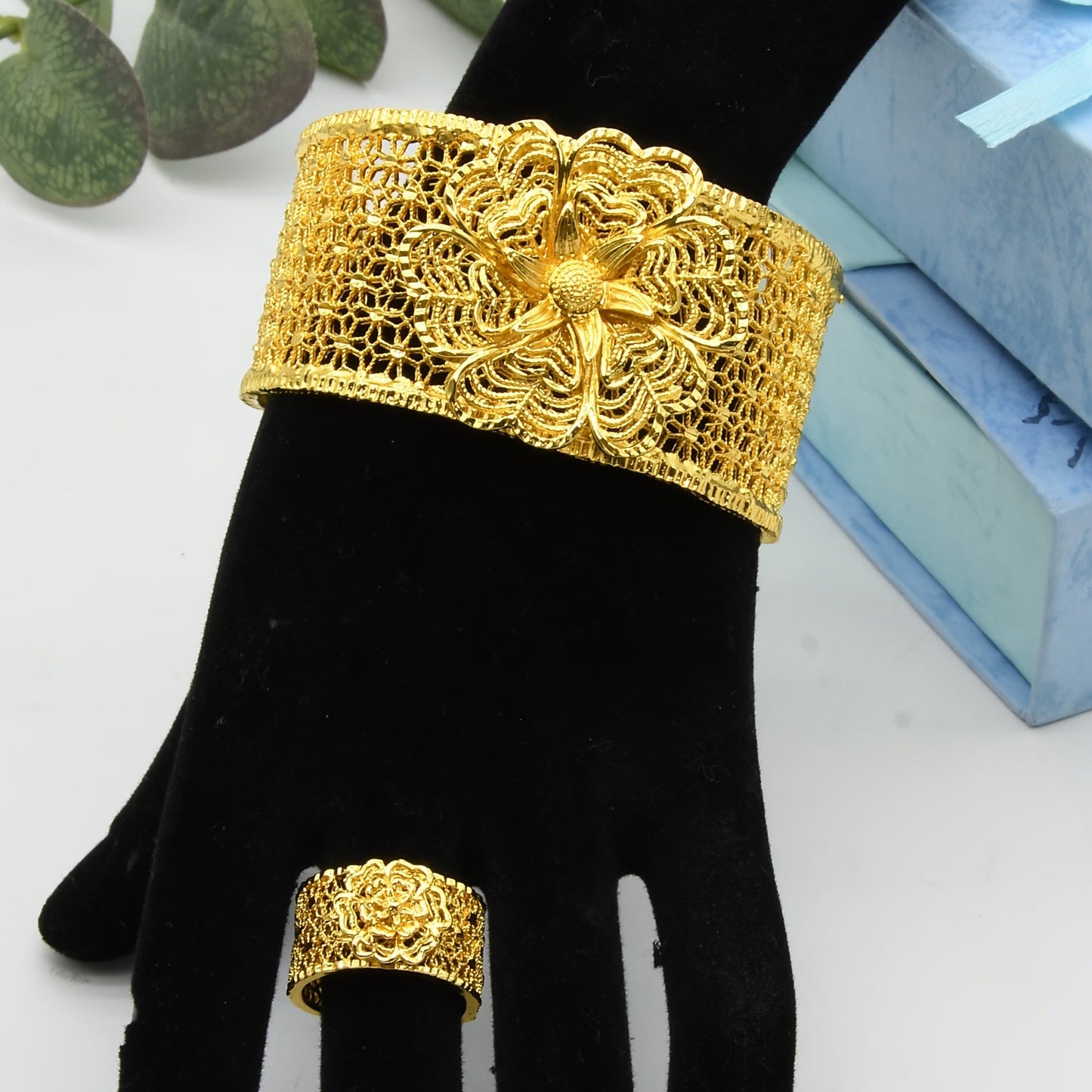 Add a touch of elegance to your outfit with this stunning set featuring a 24K golden plated zinc alloy bangle and ring. The floral design is adjustable, making it perfect for women to wear daily or for special occasions such as parties, engagements