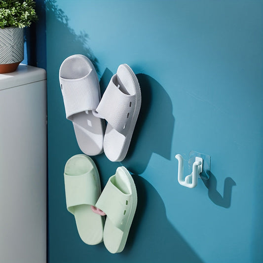 Wall-mounted slipper holder for bathroom made of non-porous plastic. Requires no batteries, easy to clean, and saves space with a single shelf design.