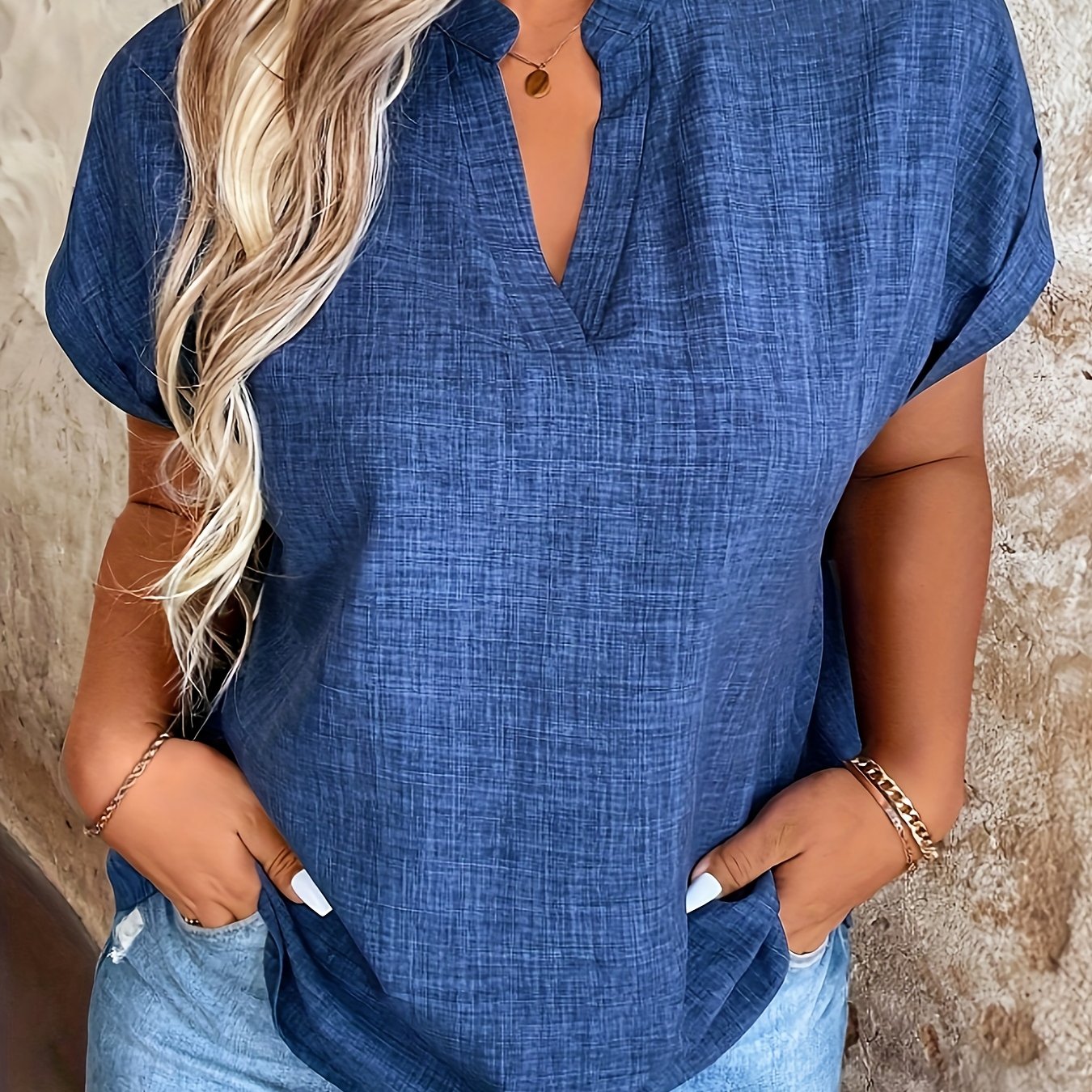 Elegant blue V-neck blouse with batwing sleeves, perfect for spring/summer. Made of machine washable polyester fabric, ideal for casual summer wear.