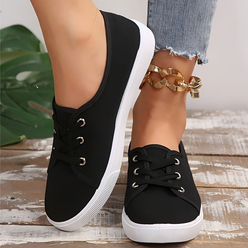 Black & white lace-up sneakers for women with round toe, low-top design, and comfortable EVA sole.