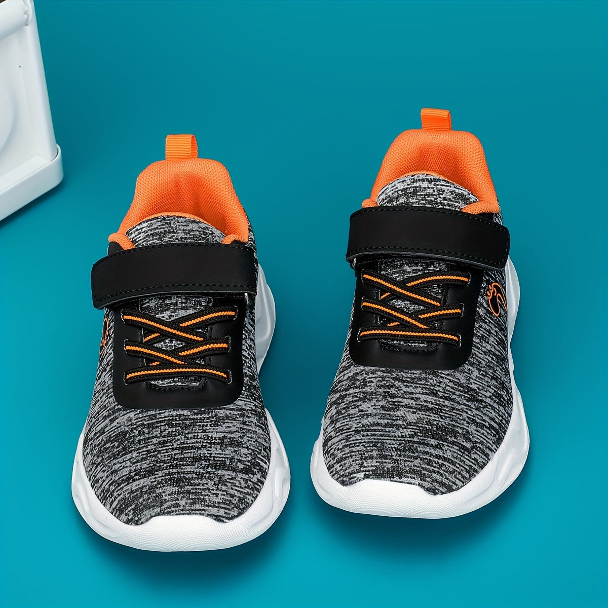 Breathable sneakers for kids with non-slip soles and hook and loop closure.