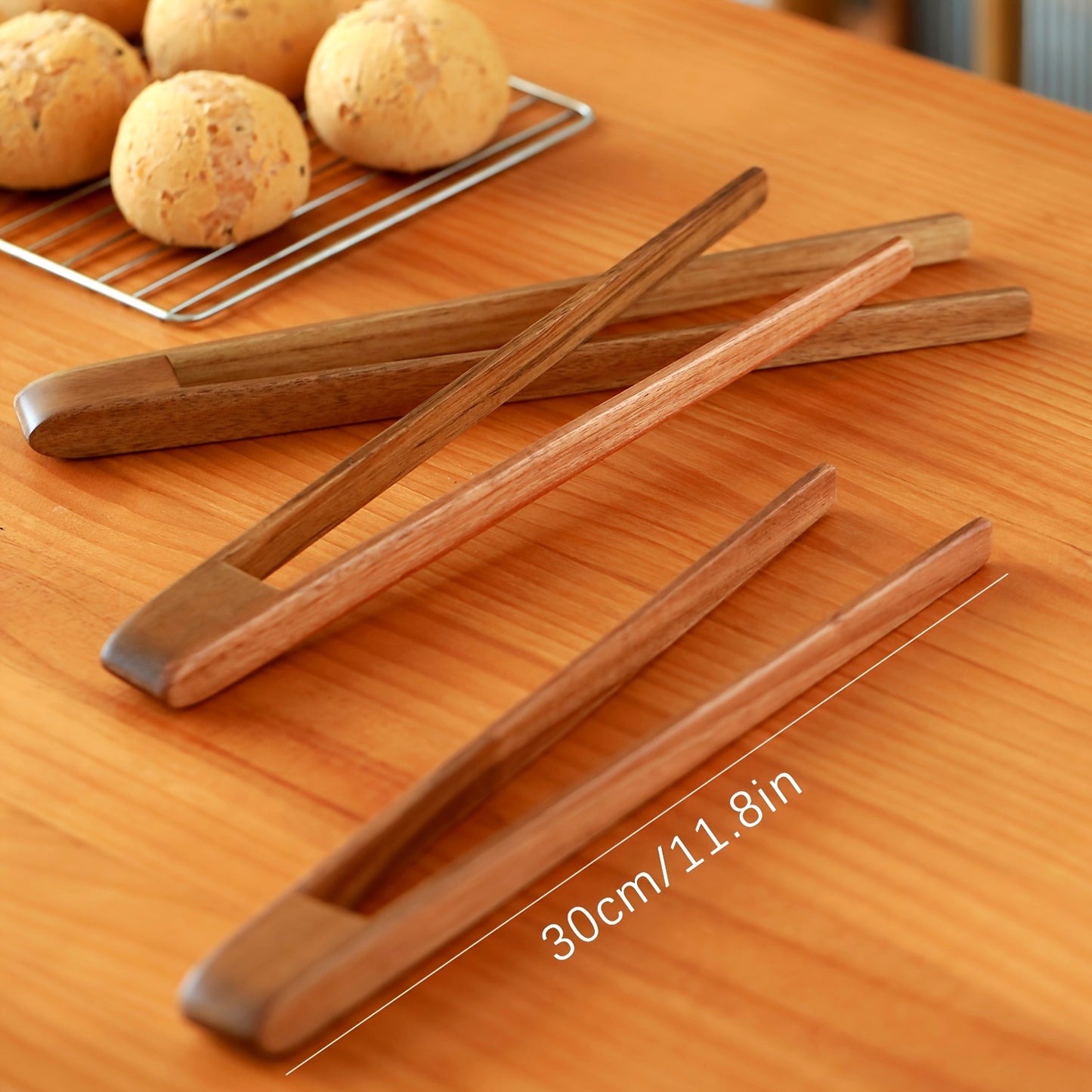 1 piece of durable wooden tongs, perfect for grilling steak and serving food at high temperatures.