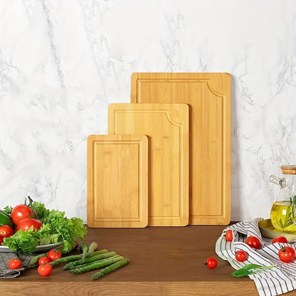 Set of 3 bamboo cutting boards with juice grooves, perfect for chopping meat and veggies. Features easy grip handles and makes a great kitchen gadgets gift.