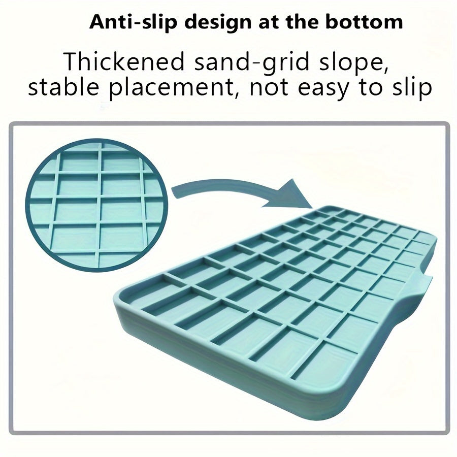 Silicone sink mat with soap dispenser, sponge drain, and countertop storage tray for drying and organizing bathroom accessories.