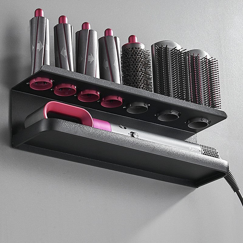 Wall-mounted metal organizer for hair dryer and curler, saving space in the bathroom.