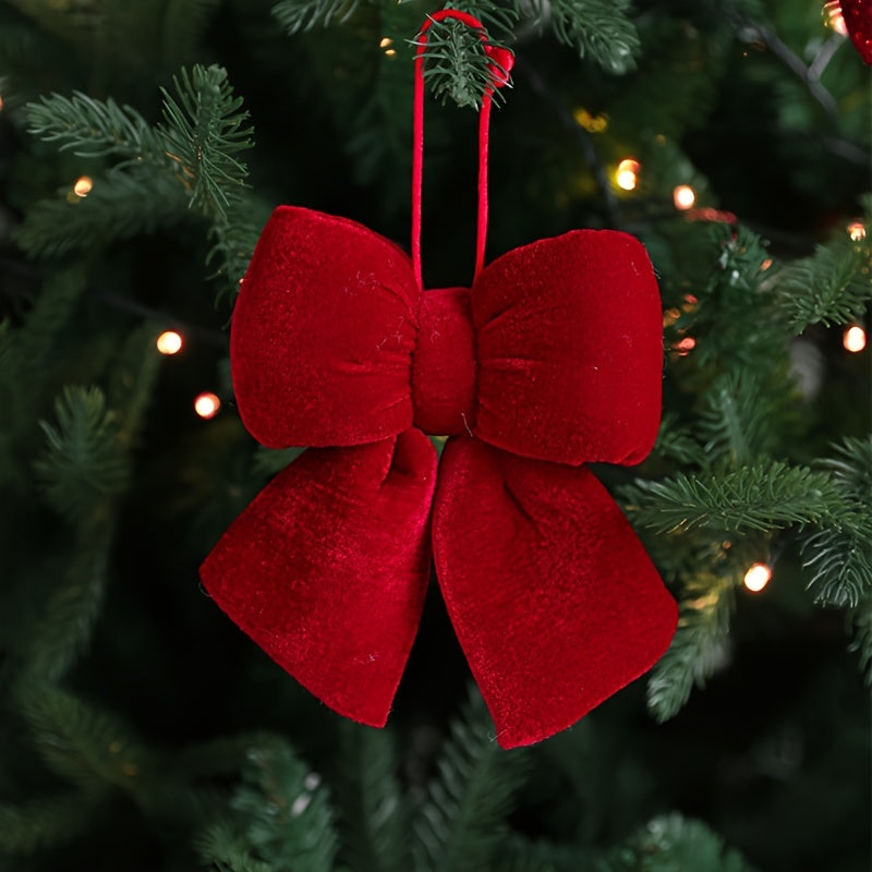 Christmas decorations include a handrail bow, fireplace bow, large velvet ornament bow, and red tree bow.