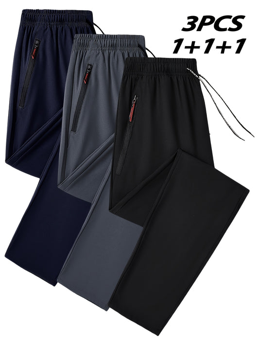 Men's casual joggers with breathable polyester fabric and zipper pockets in navy blue, gray, and black. Features an elastic waistband for fitness and running.