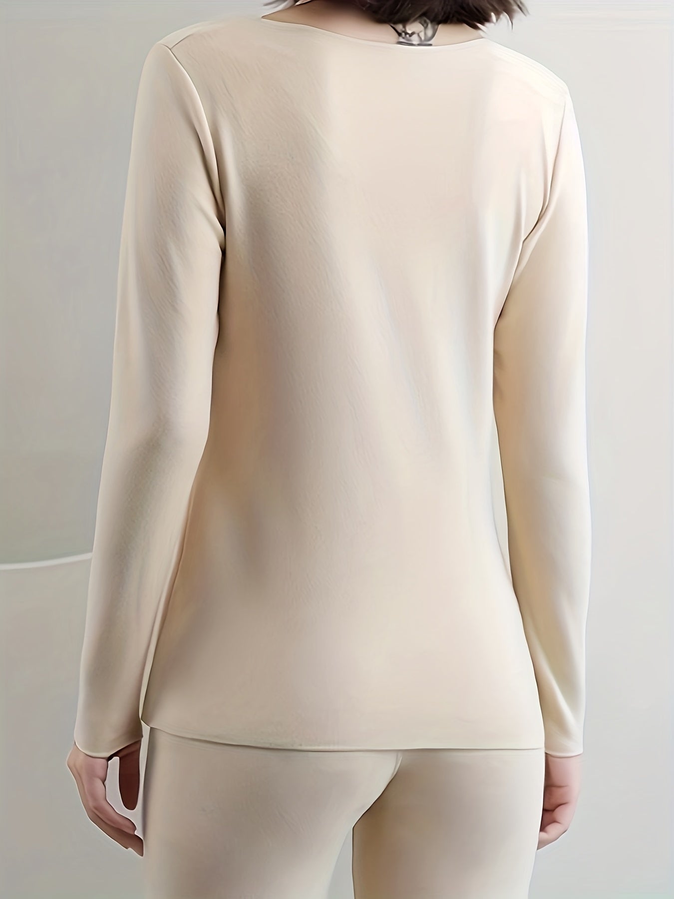 Women's solid color polyester knit fabric heated tops and pants set for winter.