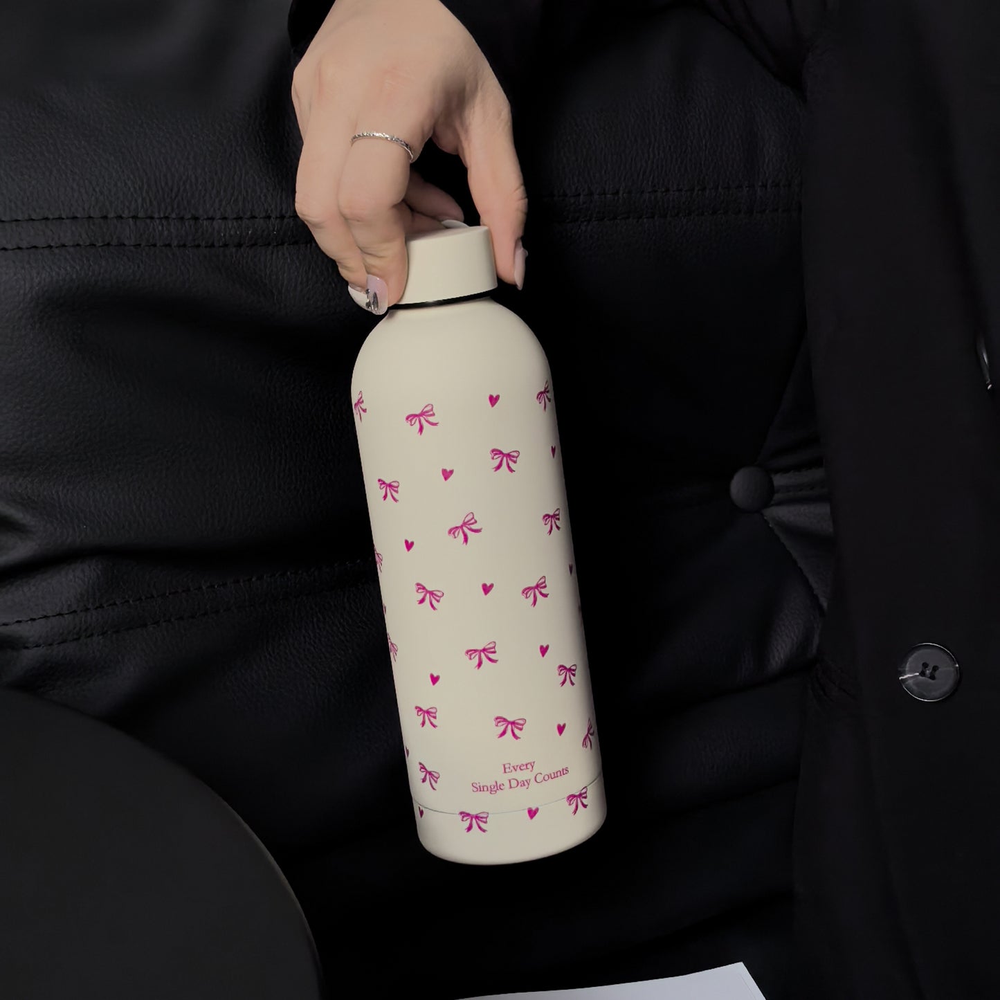 Insulated stainless steel water bottle with bowknot and heart design, perfect for travel, gym, outdoor, and car use. BPA-free and hand wash only.