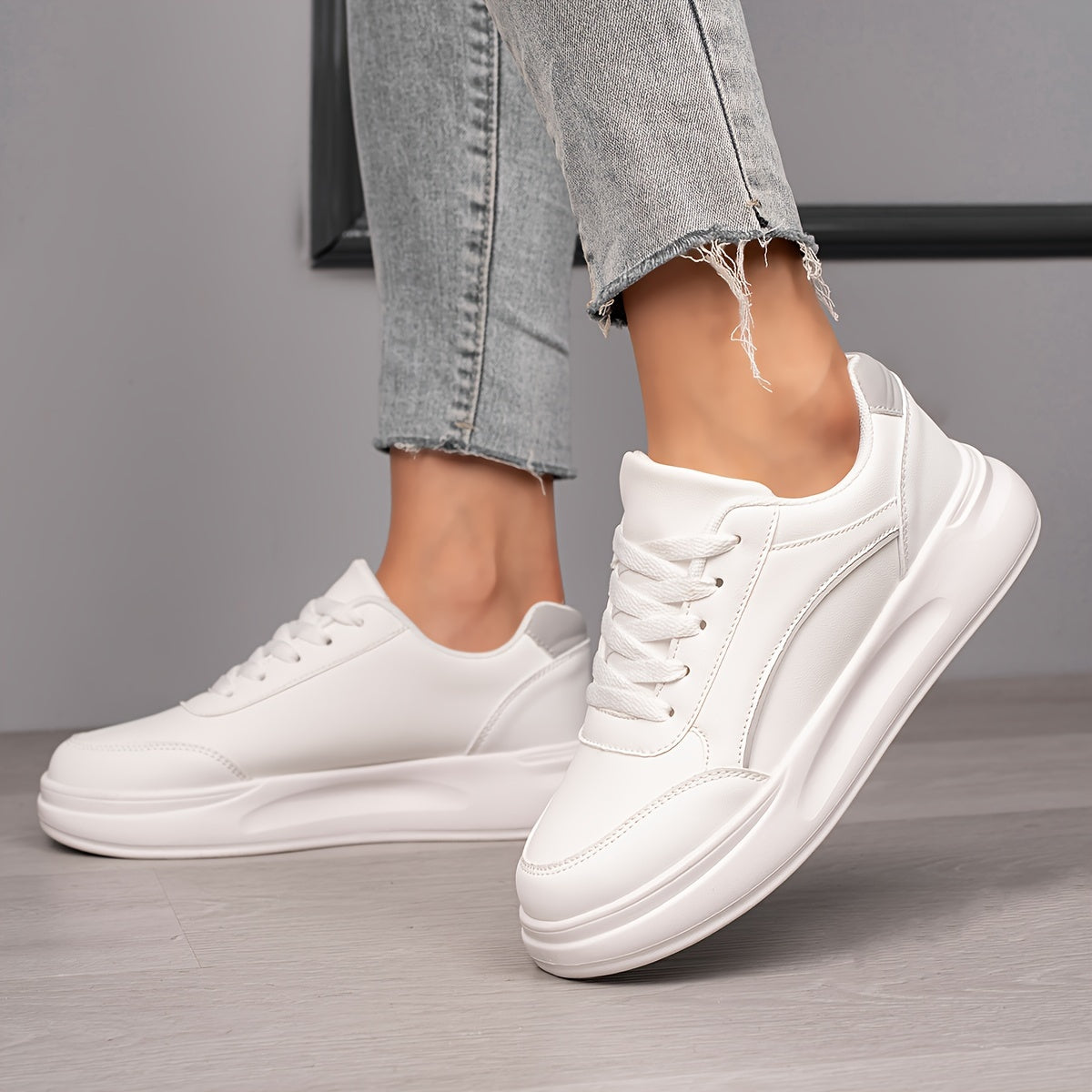 Women's white skate shoes with round toe, lace up closure, and low top flat design. Comfortable for casual wear and sports.