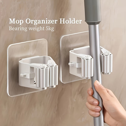 4-piece adhesive mop and broom holder for easy installation on walls with no need for drilling. Made of durable plastic, suitable for organizing bathroom and kitchen cleaning supplies, with utility hooks.