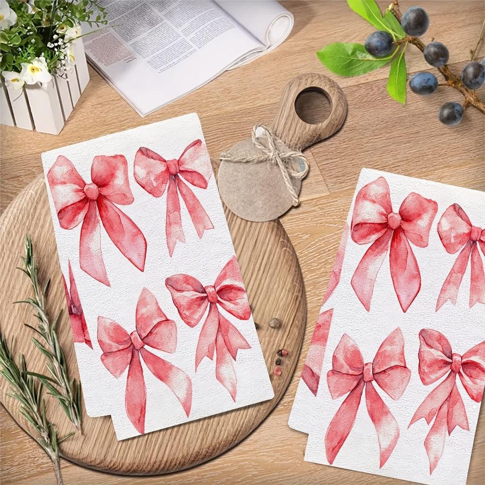 Two ultra soft kitchen towels featuring a Valentine's Day bows design. These towels are highly absorbent, machine washable, and measure 40.64x60.96 cm. The contemporary red bow pattern is perfect for holiday decor.