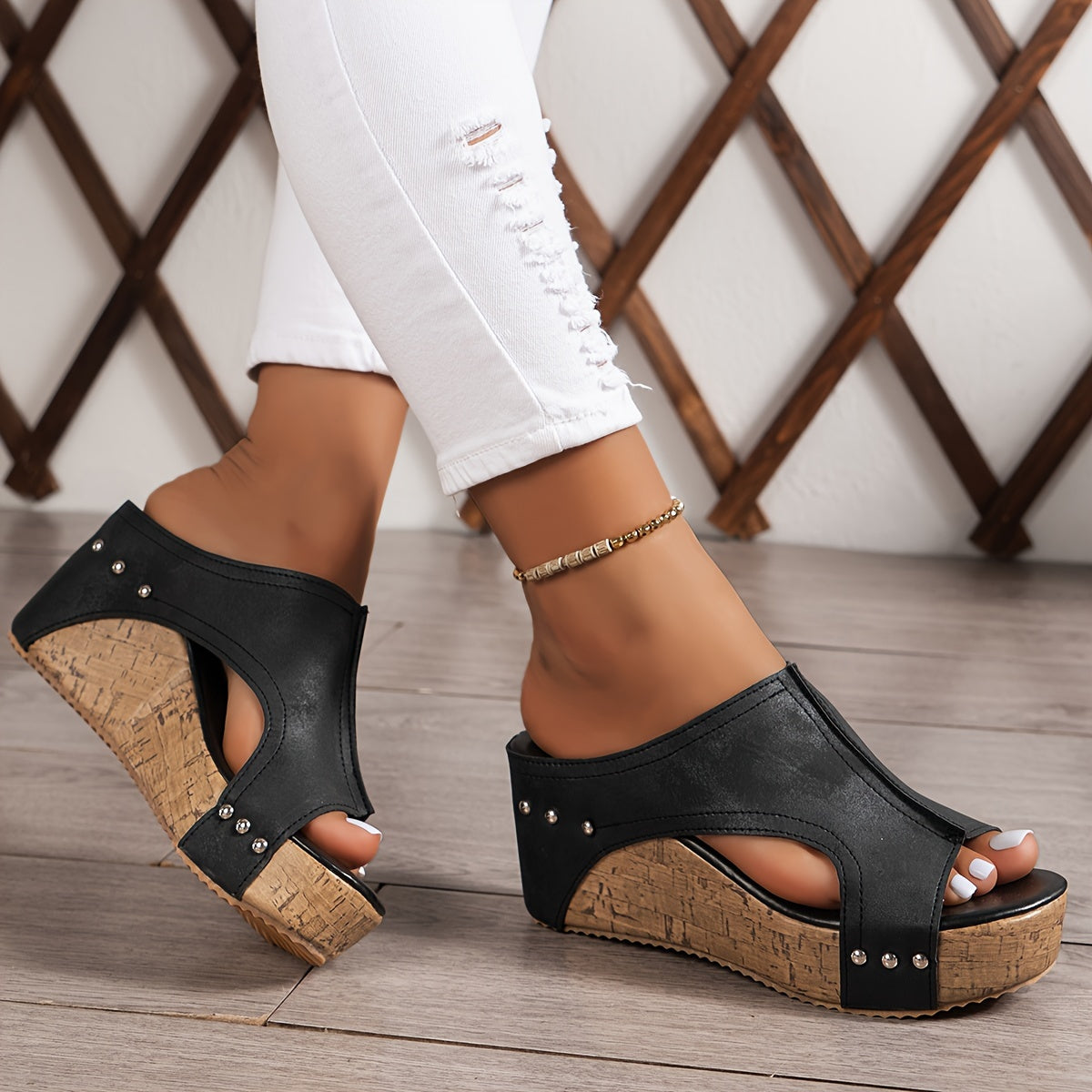 Women's platform sandals with studded decor and wedge heel.