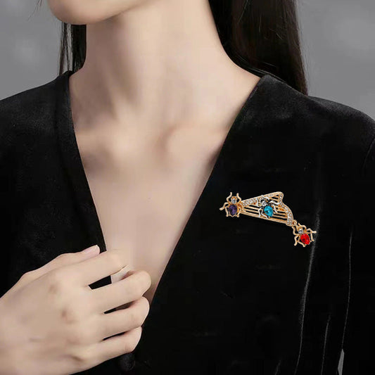 Luxurious Rhinestone Harp Insect Brooch featuring an elegant design with an irregular animal shape. This vintage-inspired fashion accessory is perfect for women who appreciate palace style and exudes a sense of senior sophistication. Add a touch of