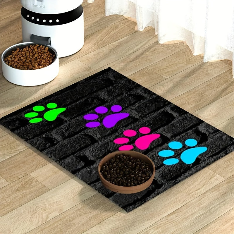 Cute paw print pet feeding mat for indoor/outdoor use, non-slip polyester material, versatile all-seasons accessory for pet food & water bowls.