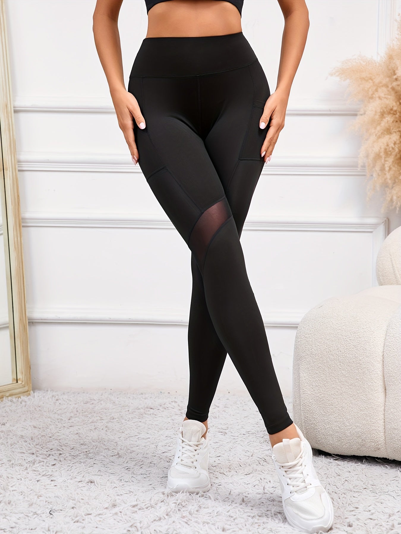 High-waist yoga leggings with pocket, comfy stretch fit, sleek black with mesh panels, perfect for everyday and workouts.