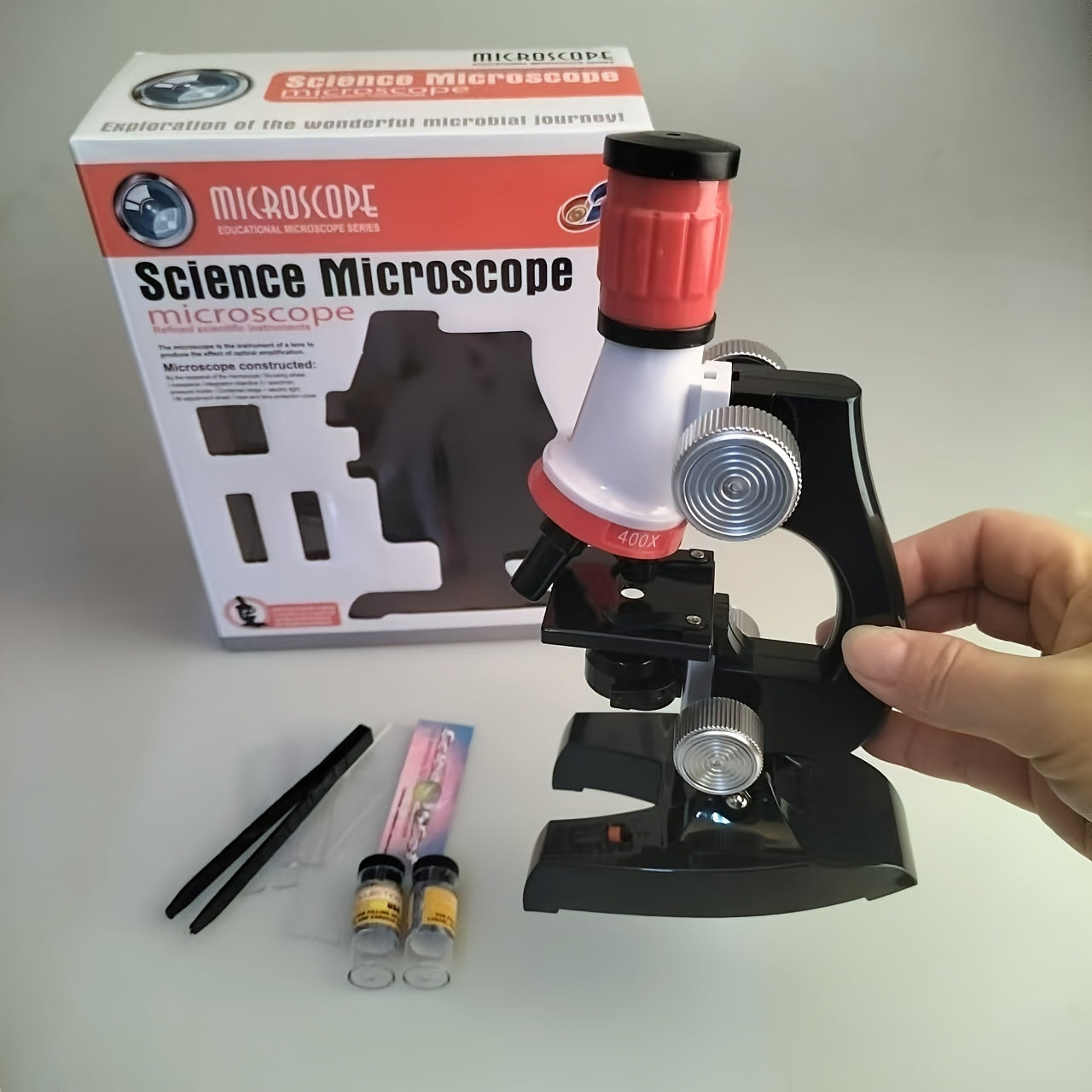 High-definition microscope set for kids with 100X-1200X magnification made of durable ABS material.