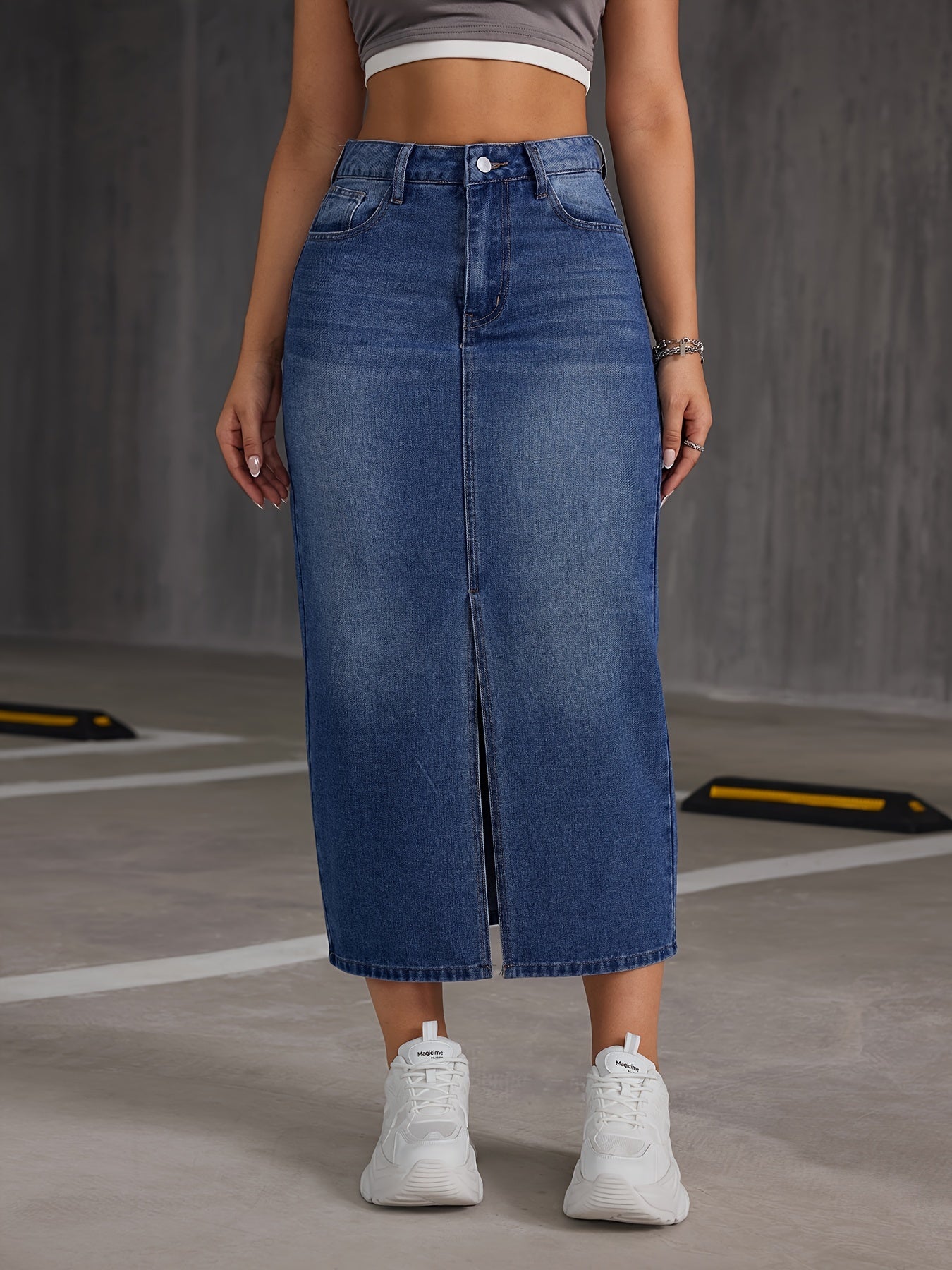 High-waisted denim midi skirt for women with a slit hem, A-line cut, and button detail. Ideal for spring, summer, and fall. Glossy texture finish.