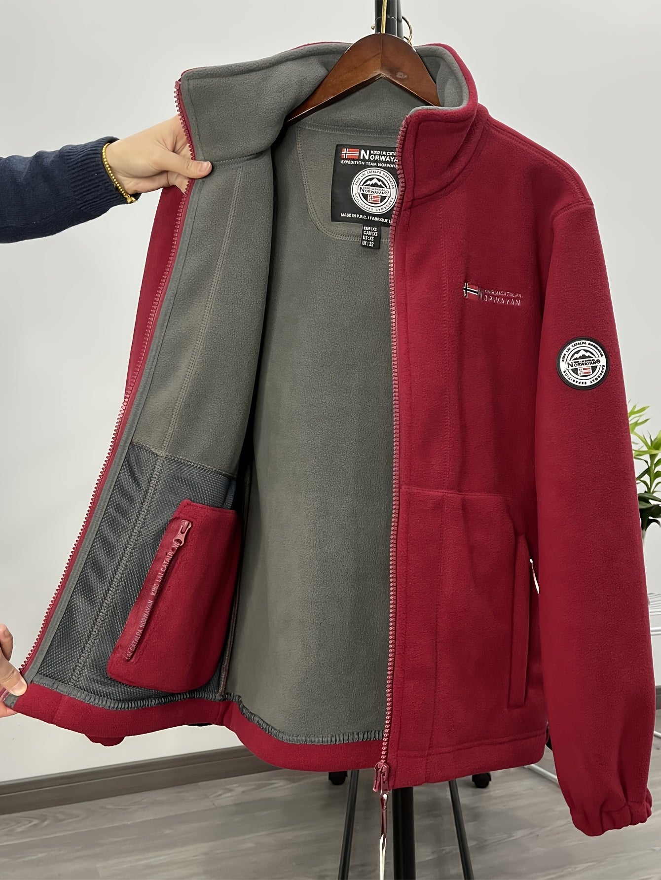 Men's winter fleece jacket with stand collar and zippered pockets, ideal for outdoor activities. Thick, windproof, and warm. Made from polyester fleece.