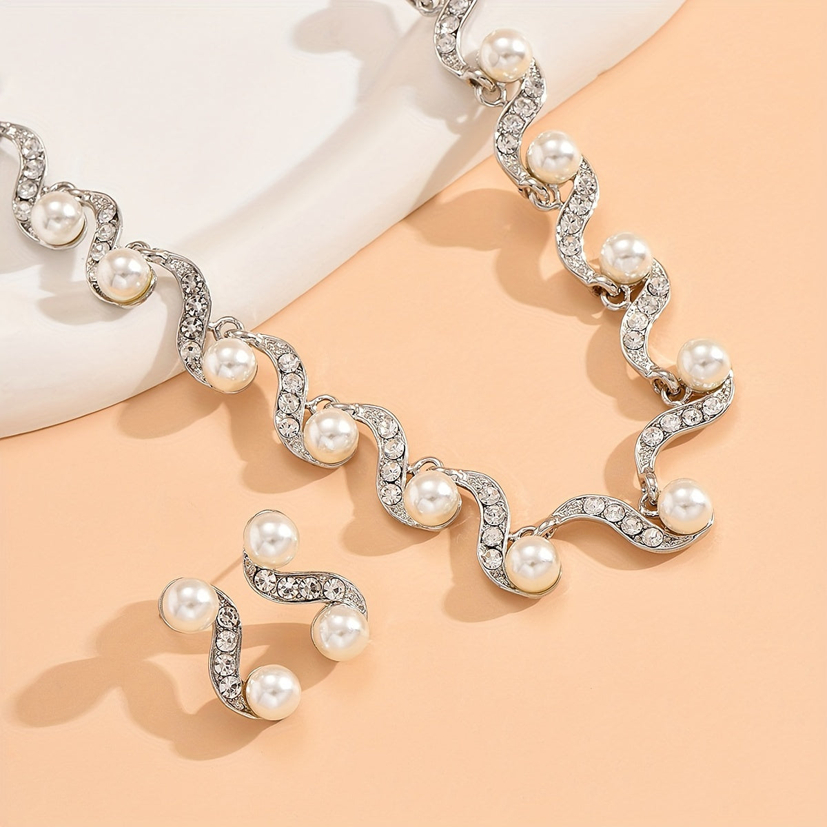 Stunning imitation pearl and diamond jewelry set, ideal for brides to wear on their special day.