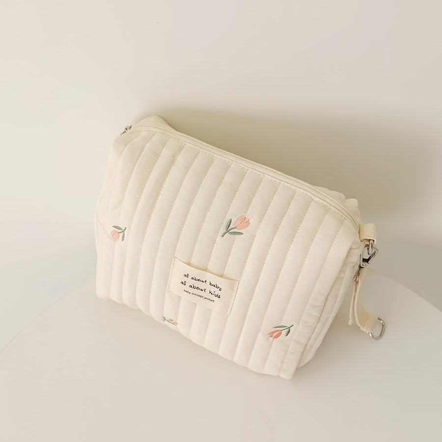 Stay organized on-the-go with this adorable Embroidered Diaper Clutch Bag designed for strollers. Made from durable polyester and featuring a quilted design, this pouch includes a secure zipper closure and cute floral embroidery. Perfect for ages 14 and