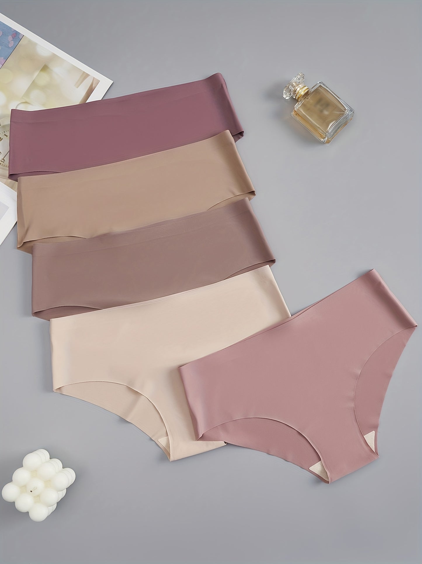 5 seamless women's briefs in assorted brown and purple shades, made from a soft and comfortable nylon blend. Low-rise with a stretch fit, non-see-through material. Comfortable lingerie with