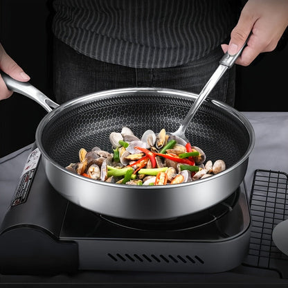 A durable kitchen essential, this 11-inch tri-ply stainless steel frying pan features non-stick coating and high sides for easy flipping and serving. It is oven and dishwasher safe, and compatible with induction, electric, and gas stoves.