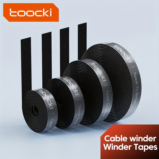 Black and gray nylon cable winder tape for iPhone, Xiaomi, and Poco for desk organization and management. Durable and adhesive under desk organizer.