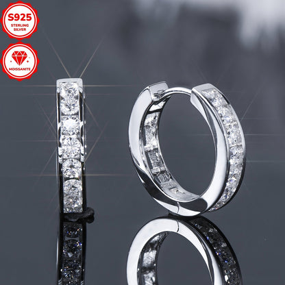 These stunning hoop earrings are crafted from 925 sterling silver and feature dazzling D color 2.5mm round moissanite stones in a track setting. The inner diameter of the earrings is 13mm, and they come with a GRA certificate. The total weight of the