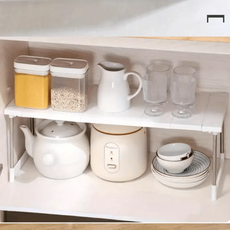 Adjustable plastic under sink organizer shelf with open storage rack for kitchen cabinet. No assembly needed, space-saving solution.