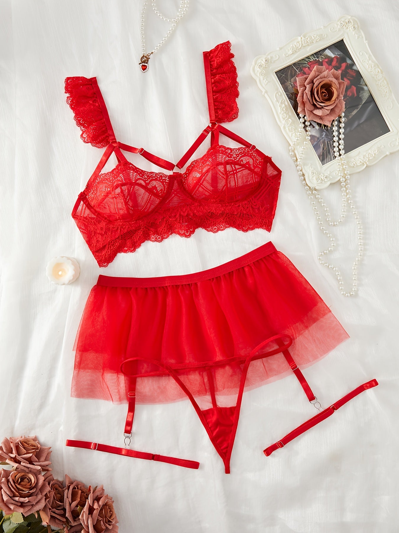 Red lace lingerie set with adjustable straps, mesh underwear, garter belt skirt, and leg garters, perfect for the bedroom.