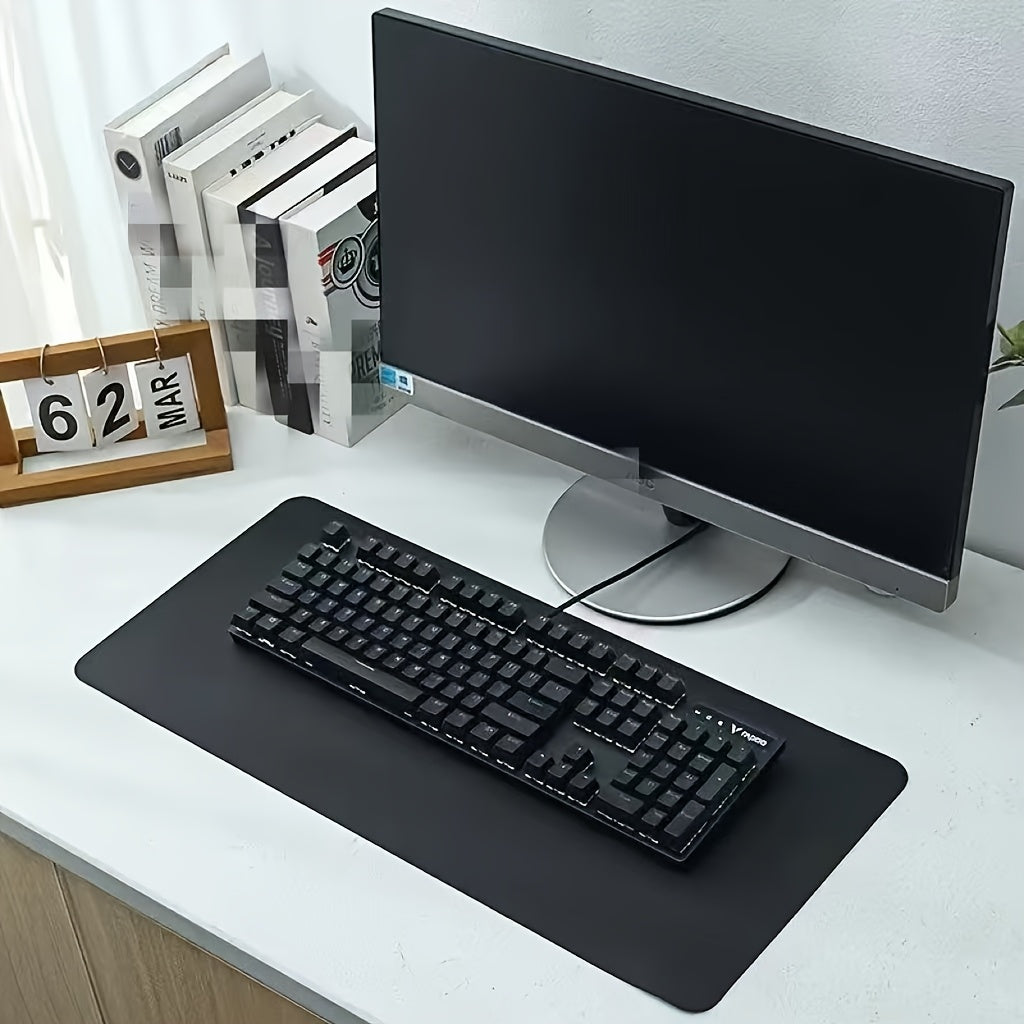 Black non-slip desk mat for office, ideal for computer and mouse.